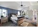 Spacious bedroom with tray ceiling, fan, sitting area and ensuite bathroom at 527 Mossycup Dr, Fairburn, GA 30213