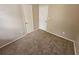 Carpeted bedroom with two doors, neutral walls, and classic trim at 6301 Creekford Dr, Lithonia, GA 30058