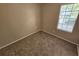 Neutral bedroom with tan walls, plush carpet, and a window providing natural light at 6301 Creekford Dr, Lithonia, GA 30058