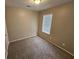 Bedroom featuring carpet floors, neutral walls, and a window at 6301 Creekford Dr, Lithonia, GA 30058