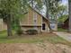 Charming two-story home with a well-maintained front yard and mature trees at 6301 Creekford Dr, Lithonia, GA 30058