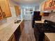 This kitchen features wood cabinets, granite countertops, stainless steel appliances, and wood floors at 6301 Creekford Dr, Lithonia, GA 30058