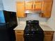 Modern kitchen equipped with black appliances, granite counters, and wooden cabinets at 6301 Creekford Dr, Lithonia, GA 30058
