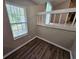 Stylish loft with wood flooring, offering a view of the living space below at 6301 Creekford Dr, Lithonia, GA 30058