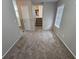 Cozy room featuring a view of the living area, neutral walls, and plush carpeting at 6301 Creekford Dr, Lithonia, GA 30058