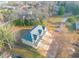 Aerial shot of a cream-colored house with grey roof in a lush, green area at 6880 Robinson St, Lithonia, GA 30058