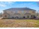 View of the back of the home showing the backyard and multi-Gathering patio space at 6880 Robinson St, Lithonia, GA 30058