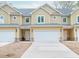 Inviting townhome boasts a 1-car garage, stone accents, and a charming covered front entrance at 6880 Robinson St, Lithonia, GA 30058