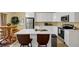 Bright kitchen with white cabinets, stainless steel appliances, and quartz countertops at 6880 Robinson St, Lithonia, GA 30058