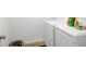 Laundry room with white washer and dryer and plenty of storage for detergent at 6880 Robinson St, Lithonia, GA 30058