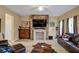 Cozy living room with stone fireplace, laminate floors, and comfortable seating at 6880 Robinson St, Lithonia, GA 30058