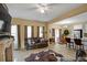 Open-concept living space with stone fireplace, sleek floors, and plenty of natural light at 6880 Robinson St, Lithonia, GA 30058