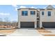 New construction townhome featuring a two-car garage and modern architectural details at 1020 Sutherland Lane (Lot 43), Lawrenceville, GA 30043