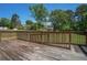 Wooden deck with railing overlooks the yard, providing a perfect spot for outdoor enjoyment at 1048 Tumblewood Trl, Lawrenceville, GA 30044