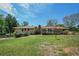 Expansive grassy backyard with mature trees and deck provides a peaceful outdoor setting at 1048 Tumblewood Trl, Lawrenceville, GA 30044