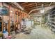 Unfinished basement ready for customization with exposed ceiling, shelving, and concrete flooring at 1048 Tumblewood Trl, Lawrenceville, GA 30044