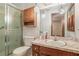 Bathroom with glass door shower, marble vanity, and wooden cabinets at 1048 Tumblewood Trl, Lawrenceville, GA 30044