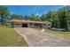 Well-maintained front yard with a long driveway leading to a brick house and garage at 1048 Tumblewood Trl, Lawrenceville, GA 30044