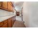 Hallway with white countertops, wooden cabinets and patterned carpet at 1048 Tumblewood Trl, Lawrenceville, GA 30044