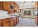 Kitchen featuring wooden cabinets and modern appliances, adjacent to the dining area at 1048 Tumblewood Trl, Lawrenceville, GA 30044