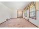 Bright living room with large windows, classic trim, and carpet flooring at 1048 Tumblewood Trl, Lawrenceville, GA 30044