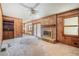 Inviting living room with fireplace, wood paneled walls, and access to additional living space at 1048 Tumblewood Trl, Lawrenceville, GA 30044