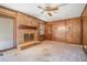 Cozy living room featuring a brick fireplace, hardwood floors, and natural light from large windows at 1048 Tumblewood Trl, Lawrenceville, GA 30044