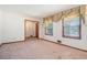 Bright living room offering large windows, carpet flooring and ample space at 1048 Tumblewood Trl, Lawrenceville, GA 30044
