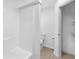 This full bathroom has a shower-tub combo, and a toilet with a neutral tile floor at 12042 Brown Bridge Rd, Covington, GA 30016