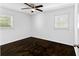 Bright bedroom with hardwood floors and a ceiling fan at 12042 Brown Bridge Rd, Covington, GA 30016