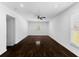Spacious bedroom with white walls, wood floors, and a ceiling fan, lit by natural light at 12042 Brown Bridge Rd, Covington, GA 30016