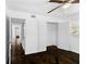 Spacious bedroom features dark hardwood floors and a closet with white doors at 12042 Brown Bridge Rd, Covington, GA 30016