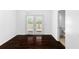 A well-lit dining room with French doors, dark wood floors, and access to a half bath at 12042 Brown Bridge Rd, Covington, GA 30016