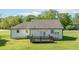 Exterior view of home featuring a large grassy yard, back porch, and white siding at 12042 Brown Bridge Rd, Covington, GA 30016