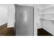 A refrigerator in a modern kitchen with nearby white pantry shelves and beautiful dark wood flooring at 12042 Brown Bridge Rd, Covington, GA 30016