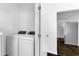Convenient laundry room near the kitchen with modern washer and dryer and stainless steel refrigerator at 12042 Brown Bridge Rd, Covington, GA 30016