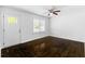 Cozy room with a ceiling fan and shiny hardwood floors near a bright white door at 12042 Brown Bridge Rd, Covington, GA 30016