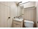 Cozy half-bathroom with charming wallpaper, vanity, and well-placed mirror and lighting at 270 Lakemoore Dr # B, Atlanta, GA 30342
