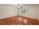 Bedroom with hardwood floors, ceiling fan, and natural light from three large windows at 270 Lakemoore Dr # B, Atlanta, GA 30342