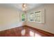 Bedroom with hardwood floors, ceiling fan, and natural light from the large windows at 270 Lakemoore Dr # B, Atlanta, GA 30342