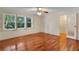 Bedroom with hardwood floors, natural light from the large windows, and an open closet at 270 Lakemoore Dr # B, Atlanta, GA 30342