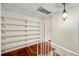 Hallway featuring hardwood floors, shelving, and warm lighting at 270 Lakemoore Dr # B, Atlanta, GA 30342