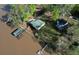 An aerial view showcases the home, its lush green surroundings, and the serene lakefront setting at 480 Friar Tuck Cir, Covington, GA 30014