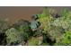 An aerial shot reveals the lakefront house and its surrounding lush greenery and boat dock at 480 Friar Tuck Cir, Covington, GA 30014