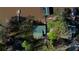 Aerial view showing lakefront home and boat dock surrounded by mature trees, and landscaped grounds at 480 Friar Tuck Cir, Covington, GA 30014