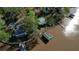 An aerial view showcases multiple homes along the waterfront and boat docks for lake access at 480 Friar Tuck Cir, Covington, GA 30014