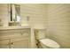 Bright bathroom with shiplap walls, a modern vanity, toilet, and updated fixtures at 480 Friar Tuck Cir, Covington, GA 30014