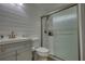 Stylish bathroom with a shiplap wall, updated vanity, toilet, and glass-enclosed shower at 480 Friar Tuck Cir, Covington, GA 30014