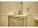 Cozy bathroom featuring shiplap walls, a modern vanity, toilet, and updated fixtures at 480 Friar Tuck Cir, Covington, GA 30014