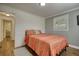 Inviting bedroom featuring wood floors, shiplap accent wall and attached ensuite bathroom at 480 Friar Tuck Cir, Covington, GA 30014